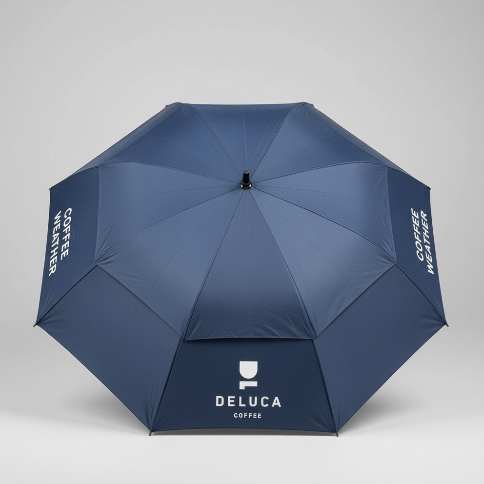 Blue umbrella with Deluca Coffee branding on a gray background